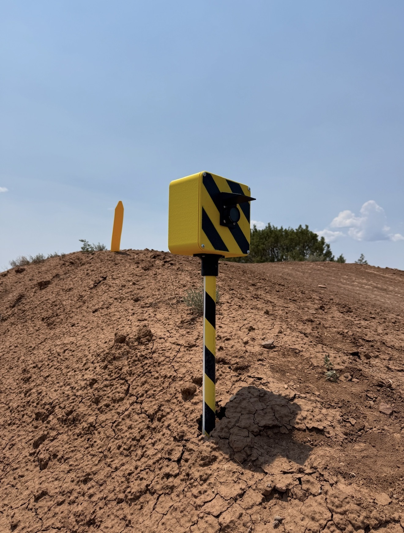 FlaggerAI AI camera mounted beside a motocross jump with a protective sun visor.