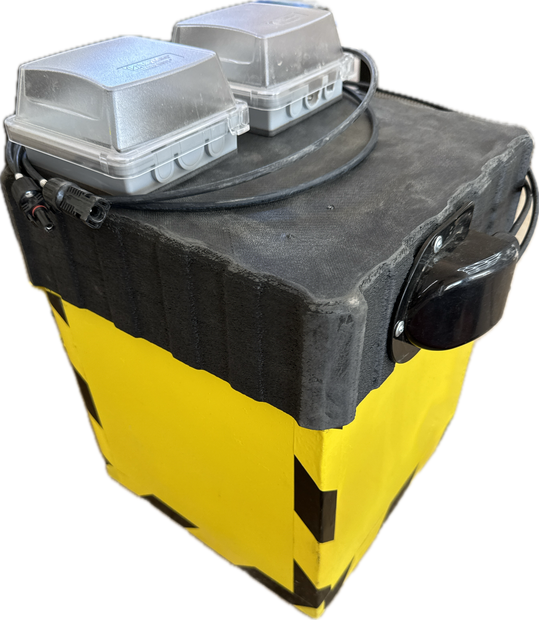 Portable yellow FlaggerAI power box with black lid and mounted waterproof enclosures.